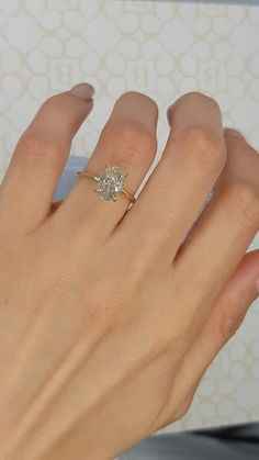 a woman's hand with a diamond ring on it