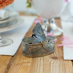 a silver box sitting on top of a wooden table