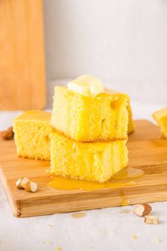 three pieces of cake sitting on top of a wooden cutting board