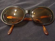 Vintage Giorgio Armani Made in Italy shades in tortoise shell with black accents. The lenses are a prescription for nearsighted. These have been used but are are in excellent condition. The hinges are still nice and tight. There are a few tiny scratches/scuffs on the lenses. These are very wearable and a classic. Please see the pics. These do not come with a case. If you need more photos let me know. Sent priority mail. For more more sunglasses, bags and accessories in my store click: https://ww Elegant Brown Oval Sunglasses, Retro Shades, British Hong Kong, Toasting Glasses, Sunglasses Retro, Plastic Sunglasses, Vintage Bunny, Vintage Gothic, More More