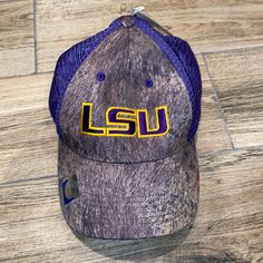 the lsu hat sits on top of a wooden floor