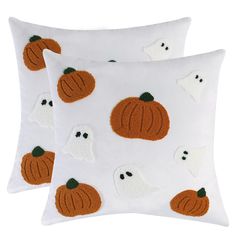 two pillows with ghost and pumpkins on them