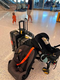 luggage and strollers are sitting on the floor in an airport