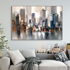 a living room with a couch, christmas tree and large painting hanging on the wall