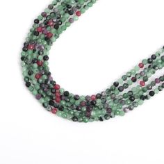 three strands of green, red and black beads