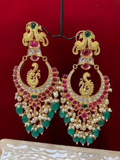 Premium quality High gold plated, pearl work, hand carved work , AD lining and kundan work. Clip back.  about 5.5 inch long  Absolute designer piece and statement earring. Luxury Kundan Danglers For Ceremonial Occasions, Luxury Green Chandbali Earrings, Luxury Ornate Chandbali Bridal Earrings, Luxury Multi-stone Chandbali Earrings, Luxury Festive Chandbalis With Peacock Design, Luxury Kundan Chandbali Chandelier Earrings, Luxury Cutdana Chandbalis For Festive Occasions, Luxury Green Chandbali Jhumkas, Luxury Fusion Chandbali Danglers