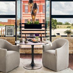 two chairs and a table in front of a window