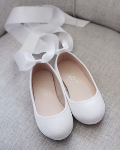 "Satin flats with wide satin ankle tie for a girl who is looking for comfort and simple chic style. DETAILS: COLORS: White, Off White, Ivory, Blush, Light Blue, Black, Wine and Champagne UPPER: Synthetic upper and lining MATERIALS: Mandmade outsole ORIGIN: Imported STYLE NAME: HARPER-57 Not sure of which size to purchase? Shoes measurements are as follow: (Please note measurements taken the length of inside of shoe from toe to heel) KIDS SIZES: Baby (Soft sole bottom): - 0-3 months: 3.75 inches Flower Girls Shoes, Simple Chic Style, Communion Shoes, Bridesmaids Shoes, Flower Girl Shoes, Satin Flowers, Simple Chic, Flower Girls, Shoes White