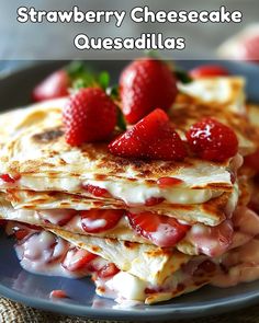 strawberry cheesecake quesadillas stacked on top of each other with strawberries