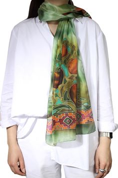 This silk scarf is designed and handmade in Armenia, by sisters Anna and Azatuhi Stepanyan. The scarf is hand painted in the technique of cold batik. The motifs include pomegranates, considered a symbol of fertility and good fortune in Armenia, as well as a guard against the Evil Eye. The multicolored scarf is framed with traditional Armenian motifs. Green Bohemian Silk Scarf, Bohemian Silk Scarf With Batik Print, Bohemian Silk Scarves As Gifts, Bohemian Silk Scarves For Gifts, Green Hand Dyed Bohemian Scarf, Handmade Green Bohemian Silk Scarf, Handmade Bohemian Green Silk Scarf, Green Bohemian Silk Scarf As Gift, Green Bohemian Silk Scarf For Gift