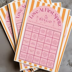 four pink and yellow striped baby shower games on top of each other with the words love at first sight written in cursive writing