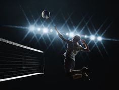 a person jumping up to hit a volleyball