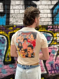 Freddie Mercury tribute printed onto this t-shirt. We're gonna make you an offer you can't refuse: the best 100% cotton tee you've ever tried. Pre-shrunk fabric? Check. Side-seamed construction? Check. Best fit ever? Double check. * 100% combed and ring-spun cotton (Heather colors contain polyester) * Fabric weight: 4.2 oz/yd² (142 g/m²) * Pre-shrunk fabric * Side-seamed construction * Shoulder-to-shoulder taping * Blank product sourced from Guatemala, Nicaragua, Mexico, Honduras, or the US This product is made especially for you as soon as you place an order, which is why it takes us a bit longer to deliver it to you. Making products on demand instead of in bulk helps reduce overproduction, so thank you for making thoughtful purchasing decisions! * Traceability: - Weaving--India, South Ko Freddie Mercury, Charlotte Nc, Shoulder Taping, Cotton Tee, Unisex T Shirt, Spun Cotton, Fabric Weights, Polyester Fabric, Bathing Beauties