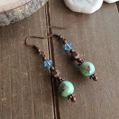 Phoenix stone earrings blue natural stone earrings boho dangle earrings copper earrings Swarovski crystal unique jewelry earrings for women These beauties have 10mm phoenix stone, which is the name for a beautiful light blue green variety of chrysocolla stone. 6mm hand hammered copper findings and 6mm blue Swarovski crystal beads, Bali beads, Copper findings and ear wire. Boho earrings. Handmade earrings. Length: 40mm approx Chrysocolla, a hydrous copper silicate, is often mistaken for turquoise Handmade Copper Drop Crystal Earrings, Handmade Copper Crystal Drop Earrings, Copper Natural Stone Drop Earrings, Copper Drop Earrings With Ear Wire, Copper Dangle Earrings With Natural Stones, Bohemian Copper Earrings With Natural Stones, Natural Stone Earrings, Stone Dangle Earrings, Unique Jewelry Gifts