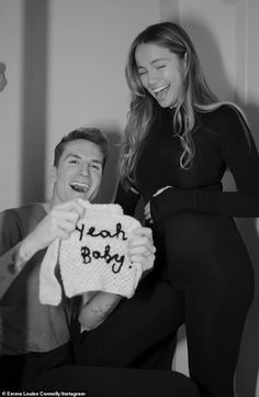 a man and woman posing for a black and white photo with the words yeah baby written on it