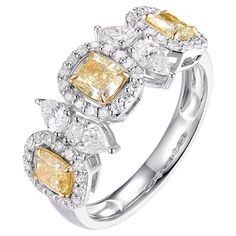 This luxurious ring is expertly crafted from 18-karat white gold and features an exquisite design adorned with fancy yellow diamonds and sparkling white diamonds. The fancy yellow diamonds, totaling 1.87 carats, are set in 18K white gold to accentuate their vibrant color, while the white diamonds provide a dazzling contrast. This elegant piece is perfect as a wedding gift or a special addition to any jewelry collection. Its sophisticated design and exceptional craftsmanship make it a timeless pi Luxury Yellow Rings With Rose Cut Diamonds, Yellow Diamond Ring With Rose Cut For Anniversary, Dazzling Brilliant Cut Yellow Diamond Ring, Dazzling Yellow Brilliant Cut Diamond Ring, Dazzling Yellow Rings With Halo Setting, Formal Yellow Rings With Rose Cut Diamonds, Fine Jewelry Yellow Diamond Platinum Ring, Yellow Platinum Diamond Ring Fine Jewelry, Yellow Diamond Ring With Halo Setting