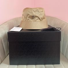 Prada Re-Nylon Bucket Hat In Beige Never Worn Perfect Condition Comes With Original Packaging And Authenticity Card From Both Prada And Vestiare Collective This Bucket Hat, An Iconic Accessory Of Prada Collections, Is Made Of Re-Nylon: Regenerated Nylon Yarn (Econyl) Produced From Recycled, Purified Plastic Trash Collected In The Ocean, Fishing Nets And Textile Waste Fibers. Product Code: 1hc137_2dmi_fof24 Enameled Metal Triangle Logo Cotton Lining Designer Beige Hat For Summer, Designer Adjustable Hats For Travel, Designer Flat Brim Travel Hat, Designer Flat Brim Hat For Travel, Designer Brown Hat For Travel, Designer Beige Wide Brim Hat, Designer Beige Adjustable Hat, Designer Wide Brim Beige Hats, Designer Adjustable Beige Hat