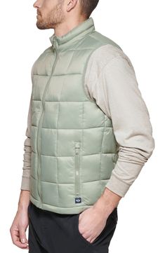 Windowpane stitching patterns turn this quilted puffer vest into a modern must-have accessory. Stand-up collar Sleeveless Front zip closure Dual front pockets Lined 100% recycled polyester Machine wash Imported Model stats: 6'1" height, 32" waist. Model is wearing size M Casual Sleeveless Puffer Jacket With Pockets, Casual Sleeveless Puffer Jacket, Casual Quilted Sleeveless Vest, Casual Quilted Nylon Vest, Quilted Sleeveless Vest For Outdoor, Outdoor Quilted Sleeveless Vest, Outdoor Sleeveless Quilted Vest, Sleeveless Quilted Vest For Outdoor Activities, Stitching Patterns