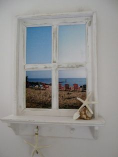 a starfish is sitting on the ledge of a window in a room with white walls