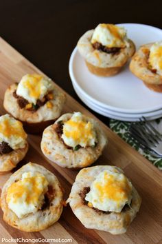 mini cheeseburger muffins on a cutting board next to a white plate