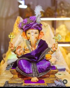 an elephant statue sitting on top of a wooden table