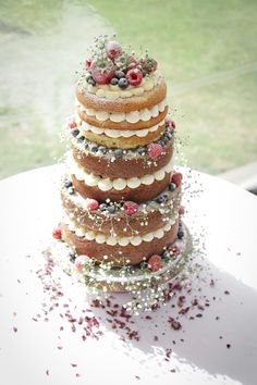 a multi layer cake sitting on top of a white table