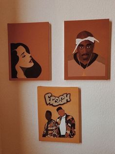 three paintings on the wall of a room with two men's faces and one woman's head