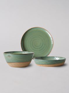 two green and brown bowls sitting next to each other