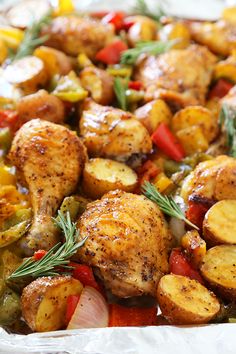 chicken, potatoes and peppers in foil with rosemary garnish on the top side