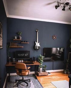 a living room filled with furniture and a flat screen tv on top of a wooden table