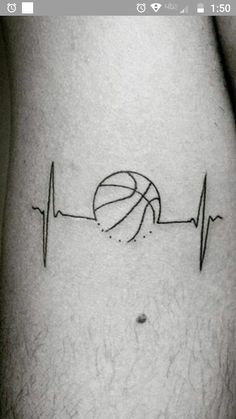 a basketball on the side of a man's leg with a heartbeat line tattoo