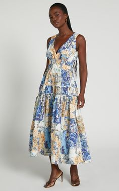 Step into the fashion spotlight with our Emily Midi Dress - Plunge Tiered Midi In Patchwork Floral. This stunning blue dress combines a playful patchwork floral print with a figure-flattering A-line silhouette, making it an absolute must-have for any occasion. The plunging neckline adds a touch of allure, while the midi length and sleeveless design keep it chic and sophisticated. Whether you're dressing up for a cocktail party or simply want to feel fabulous on date night, this dress is sure to Spring V-neck Patchwork Maxi Dress, Spring V-neck Maxi Dress With Patchwork, Chic Floral Patchwork Dresses, Floral Patchwork V-neck Dress For Summer, V-neck Floral Patchwork Summer Dress, Summer Floral Patchwork V-neck Dress, Blue A-line Dress With Patchwork, Chic Floral Patchwork Summer Dresses, Chic Summer Dresses With Floral Patchwork