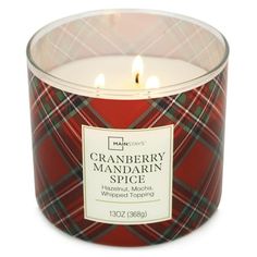 a red and green plaid candle in a glass container