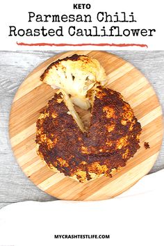 a grilled cauliflower on a wooden plate with text overlay that reads keto parmesan chili roasted cauliflower