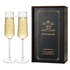 two champagne flutes in front of a black box with the 25th anniversary written on it