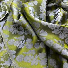 a green and white fabric with flowers on it