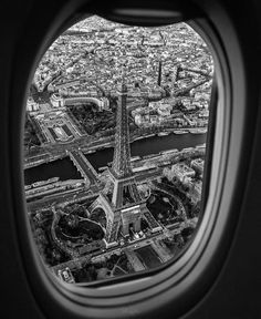 an aerial view of the eiffel tower in paris, france taken through an airplane window