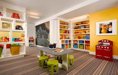 a child's playroom with toys and bookshelves