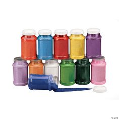 there are many different colors of paint in the jars and next to each other