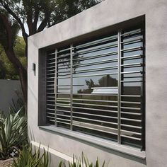 a window with metal bars on the side of it