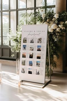 a white sign sitting on top of a table next to candles