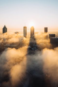 an aerial view of the city in the clouds