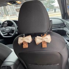 two bow ties on the back seat of a car, in front of a steering wheel