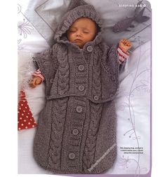 a baby doll in a knitted coat and hat