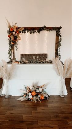 the table is decorated with feathers and flowers