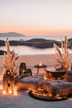 an outdoor seating area with candles and lights