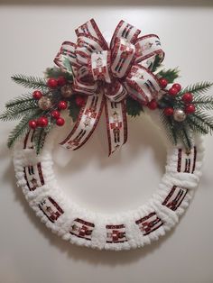 a christmas wreath with red, white and green decorations