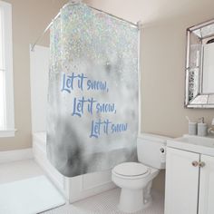 a bathroom with a shower curtain that says let it snow, let it snow on the wall