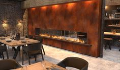 an empty restaurant with tables and chairs in front of a fire place on the wall