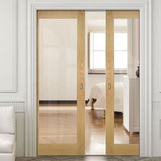 an empty room with white walls and wooden doors